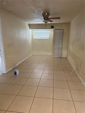 a view of a livingroom with a chandelier and glass door