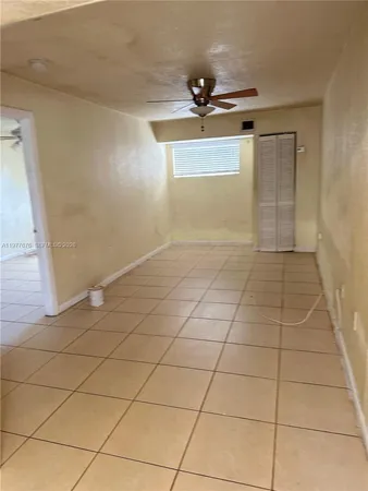a view of an empty room and a window