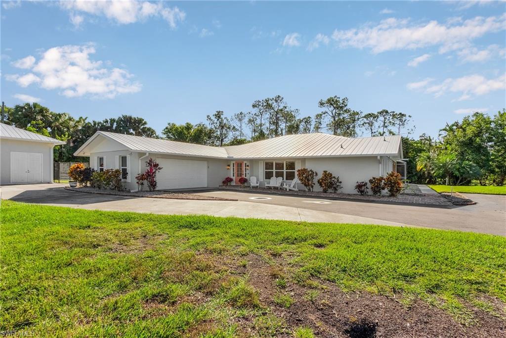 2950 Coach House Lane Naples, FL 34105 - Photo 2 of 50 a view of a house with swimming pool and a yard