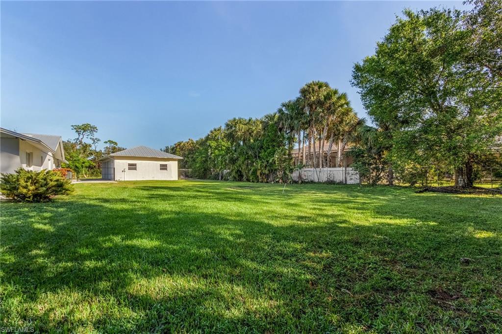 2950 Coach House Lane Naples, FL 34105 - Photo 32 of 50 a front view of a house with garden