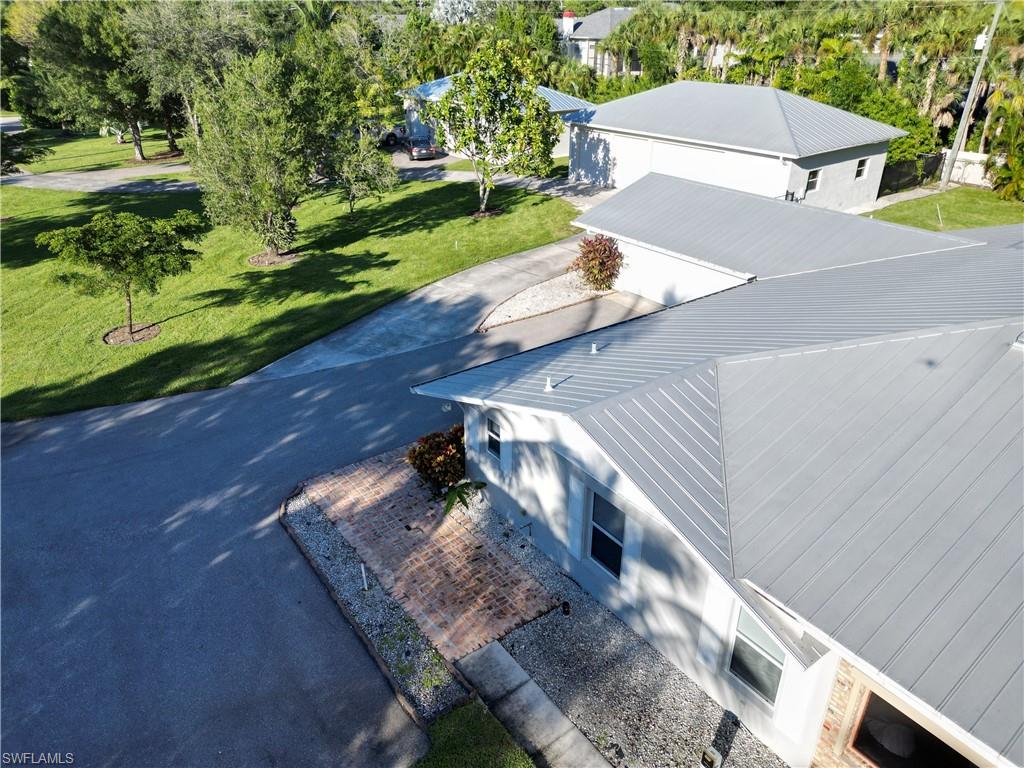 2950 Coach House Lane Naples, FL 34105 - Photo 38 of 50 a view of a yard with an outdoor space