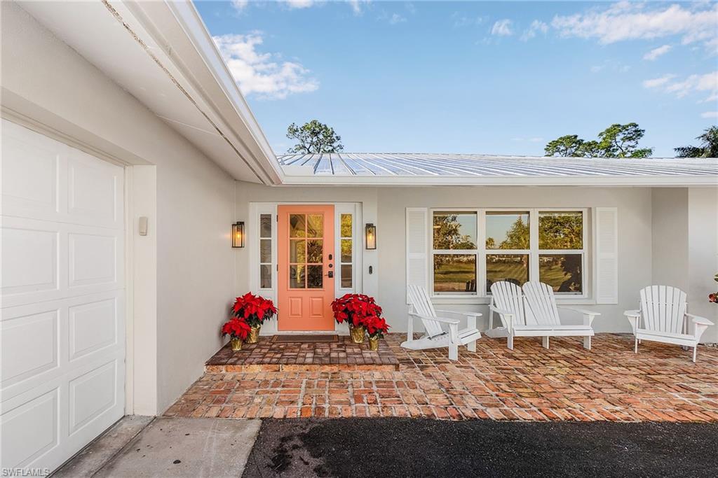 2950 Coach House Lane Naples, FL 34105 - Photo 4 of 50 a bed room with a bed and window