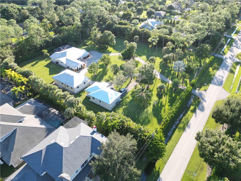 2950 Coach House Lane Naples, FL 34105 - Photo 49 of 50 an aerial view of a house with a yard