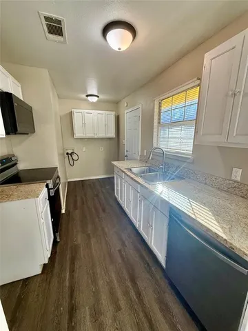 a kitchen with sink cabinets and window