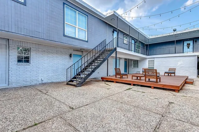 a view of a house with pool table and chairs