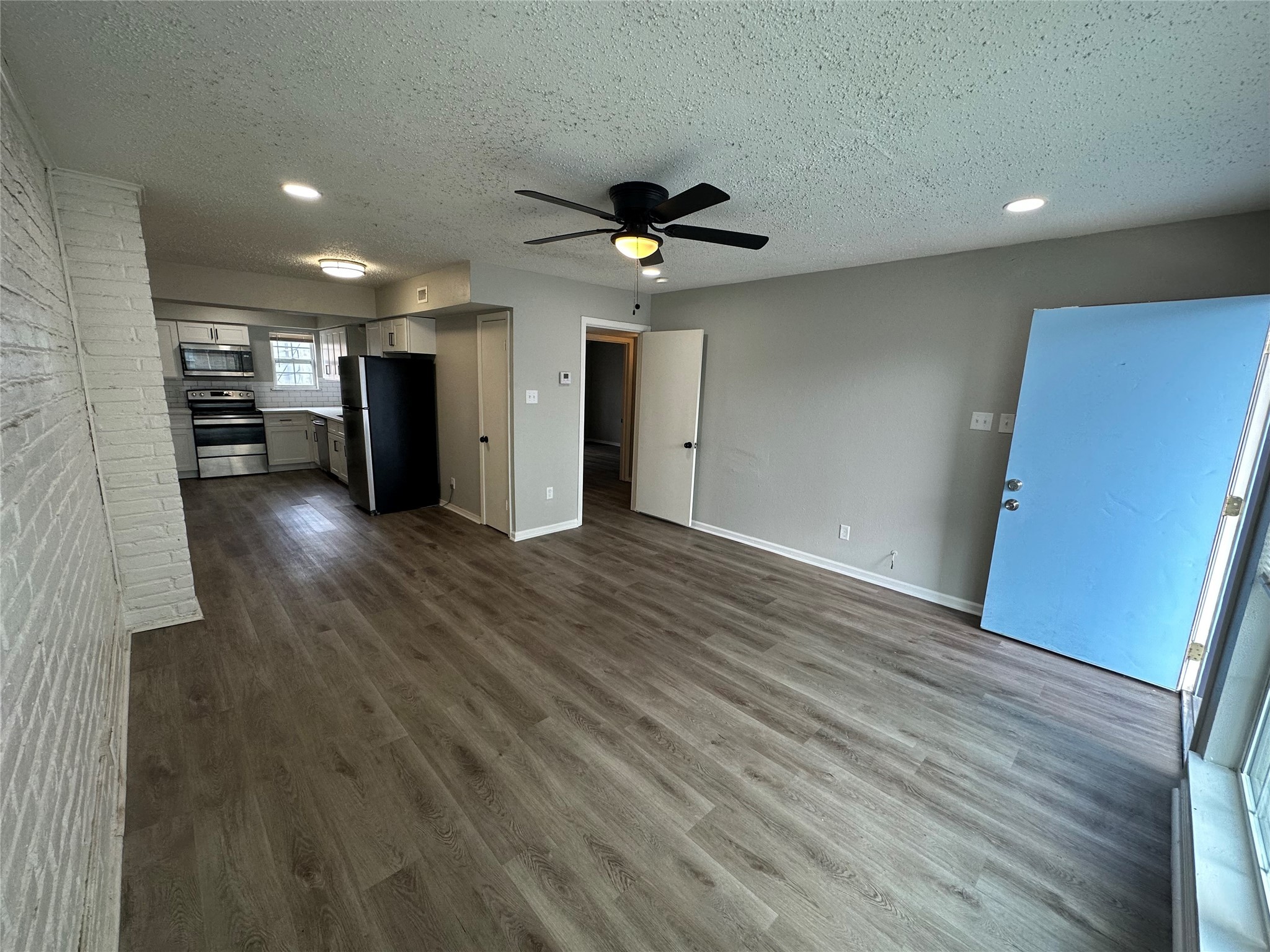 9711 Linkmeadow Lane, Unit 11 Houston, TX 77025 - Photo 6 of 19 wooden floor in an empty room with a window