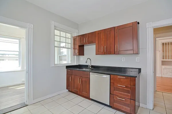 a kitchen with granite countertop a sink and cabinets