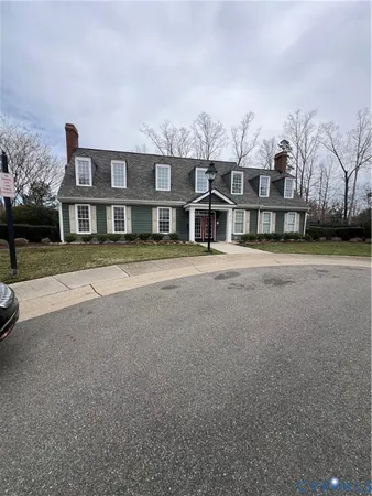 a front view of a residential apartment building with a yard