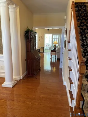 a view of entryway and hall with wooden floor
