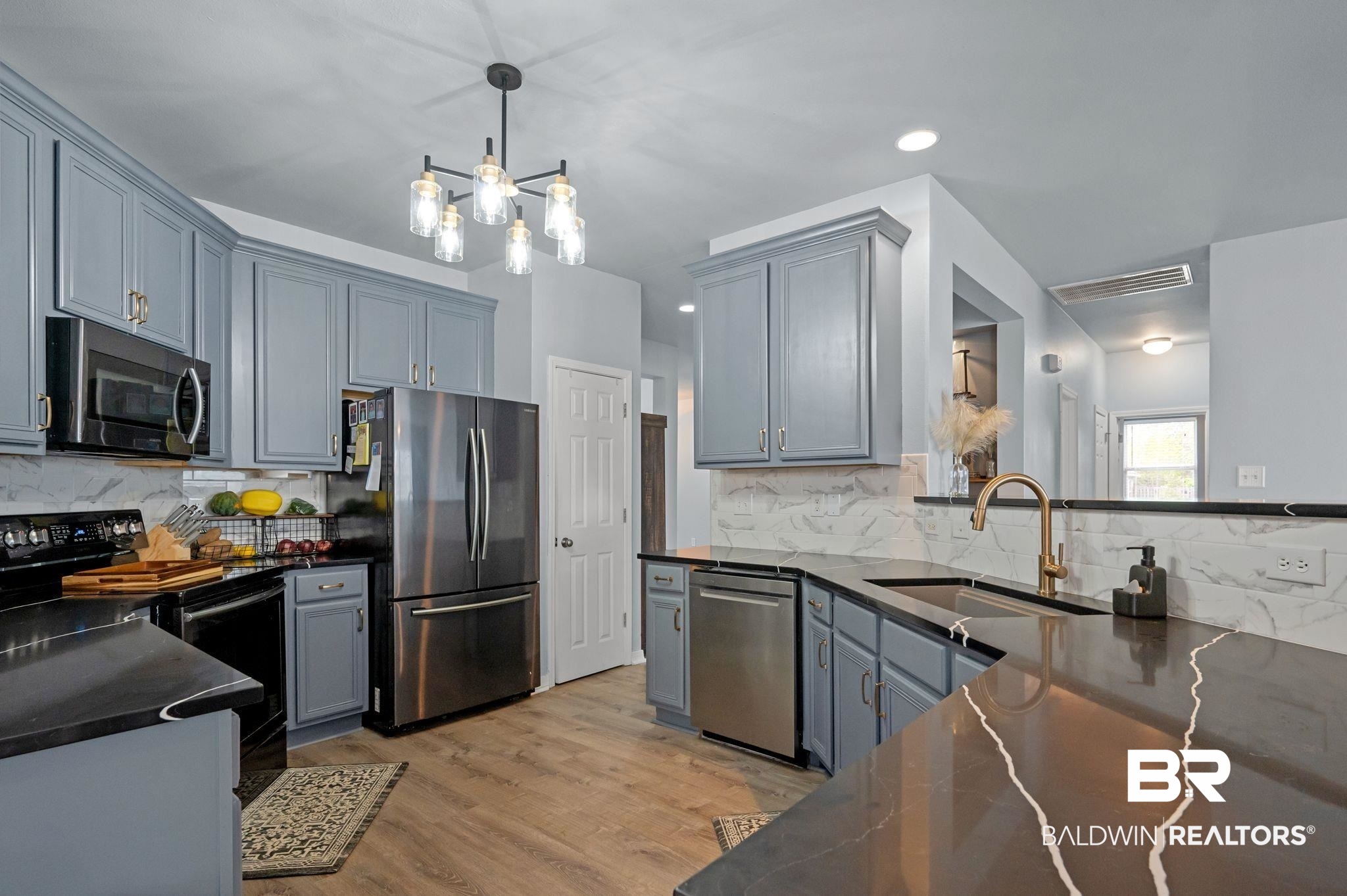 1287 Pembroke Way Foley, AL 36535 - Photo 18 of 39 Kitchen with stainless steel appliances, dark stone counters, light wood-type flooring, gray cabinetry, and tasteful backsplash