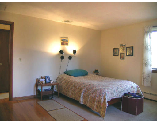 122 South Acton Road Stow, MA 01775 - Photo 13 of 21 a bedroom with a bed and a chandelier