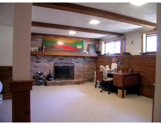 122 South Acton Road Stow, MA 01775 - Photo 15 of 21 a living room with furniture a fireplace and a flat screen tv