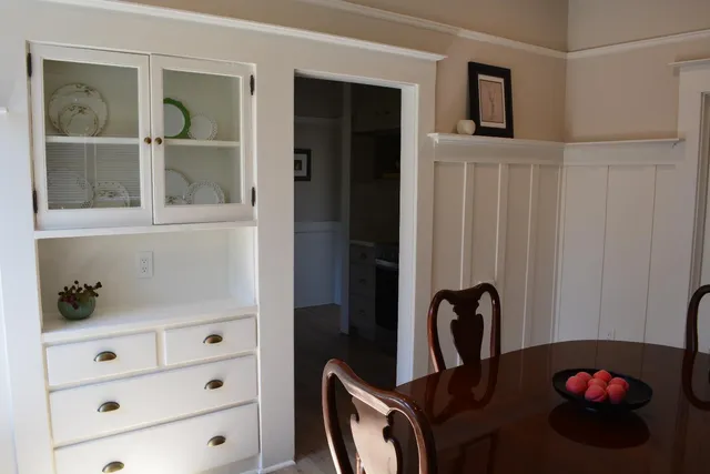 a bathroom with a granite countertop sink a mirror a vanity and shower