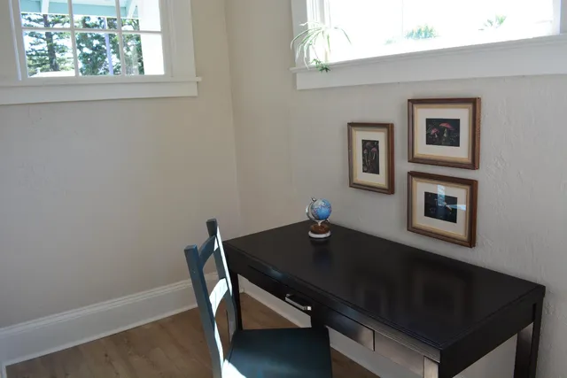 a kitchen with a sink cabinets window and wooden floor