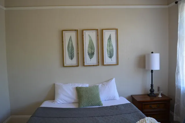 a view of a room with furniture and wooden floor