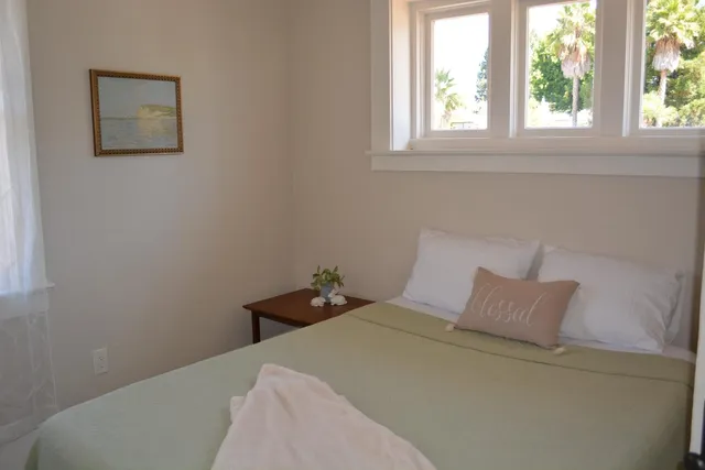 a view of a deck with a floor to ceiling window and wooden fence
