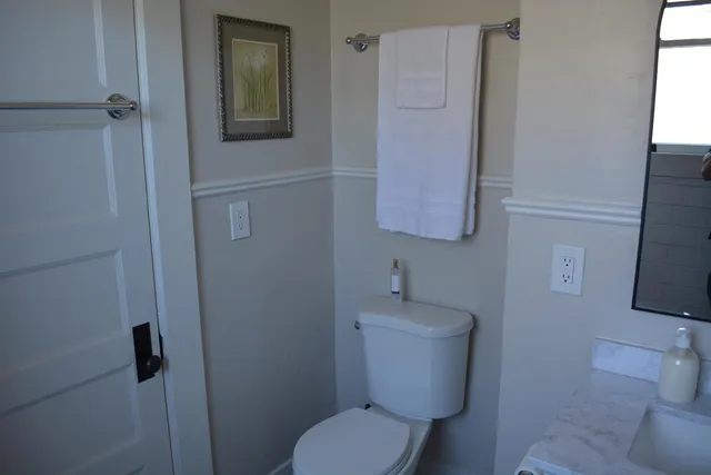 a front view of house with garage and trees