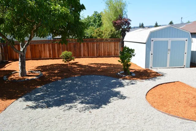 a kitchen with white cabinets and a window
