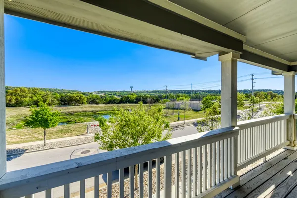 a view of balcony with a yard