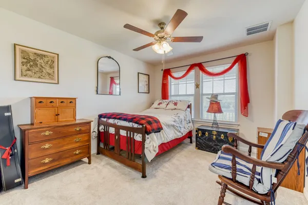 a bedroom with a bed next to a window