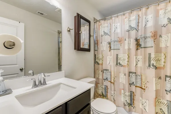 a bathroom with a sink toilet and shower