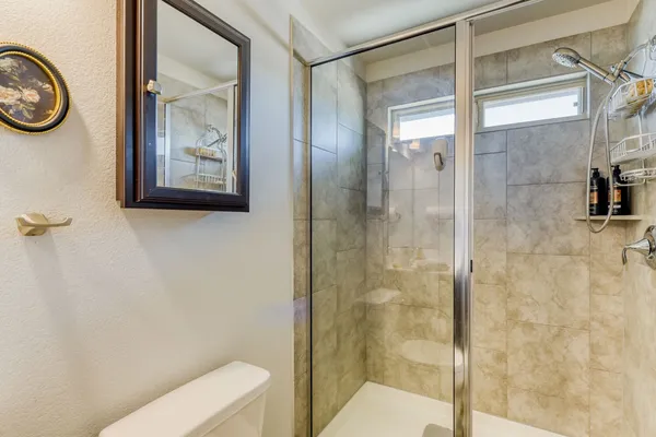 a bathroom with a toilet and a shower