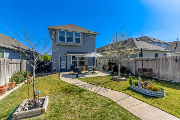 a view of a house with swimming pool and sitting area