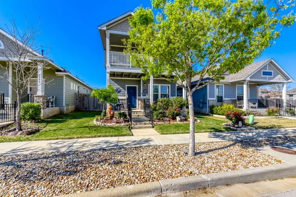 a view of a house with backyard porch and sitting area