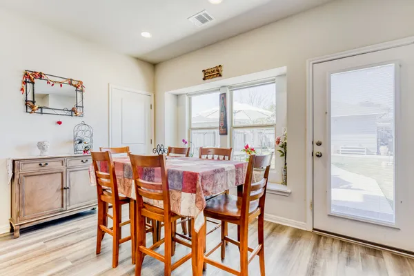 a dining room with furniture and window