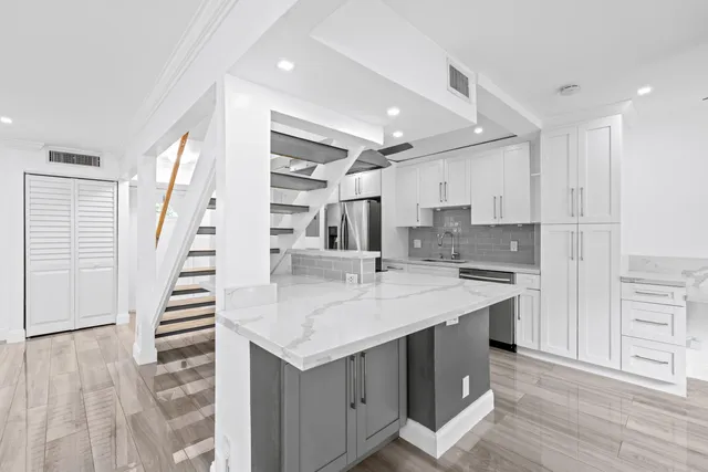 a kitchen with a sink and a refrigerator