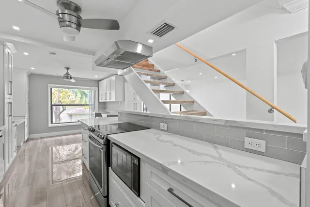 a kitchen with a sink appliances and a counter top space