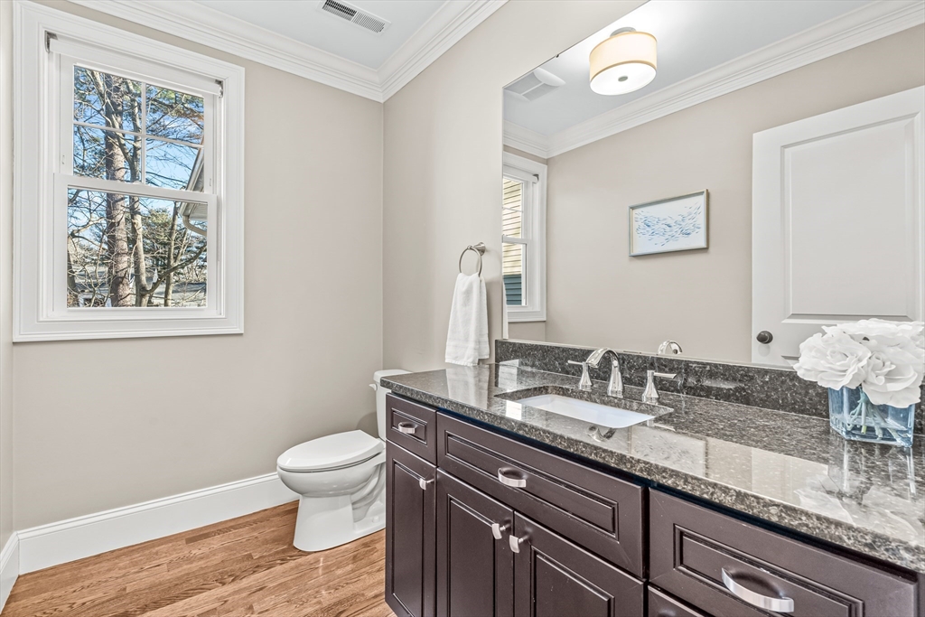 5 Rolling Lane Natick, MA 01760 - Photo 12 of 30 a bathroom with a granite countertop sink a toilet and a mirror