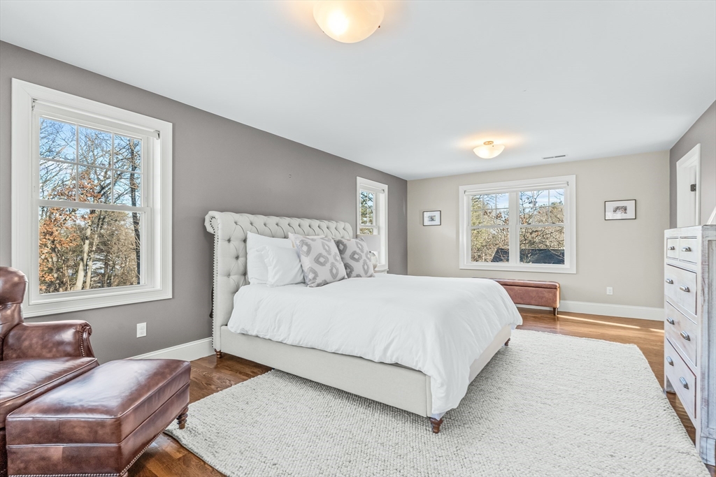 5 Rolling Lane Natick, MA 01760 - Photo 16 of 30 a bedroom with a bed and wooden floor