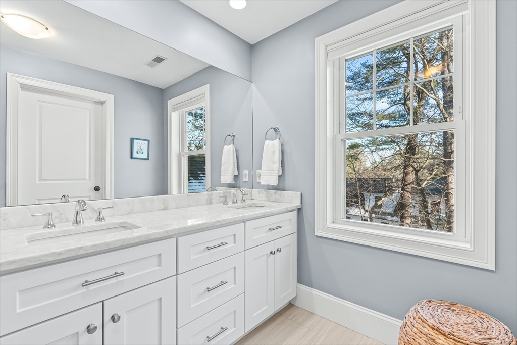5 Rolling Lane Natick, MA 01760 - Photo 18 of 30 a bathroom with a granite countertop sink mirror and a window