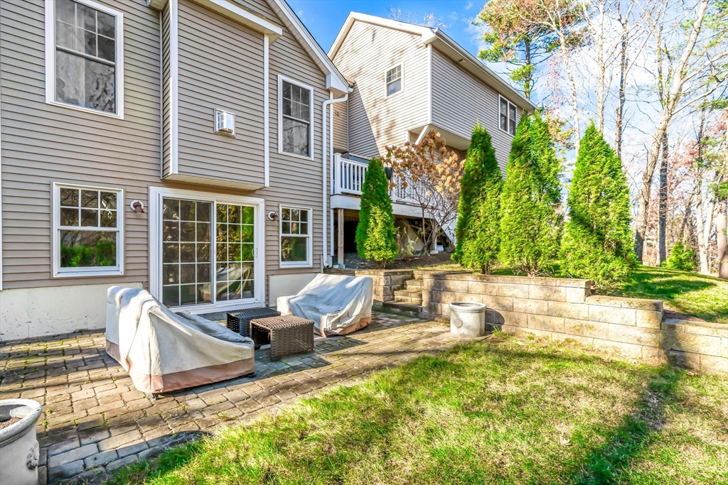 5 Rolling Lane Natick, MA 01760 - Photo 26 of 30 a view of a house with backyard and sitting area