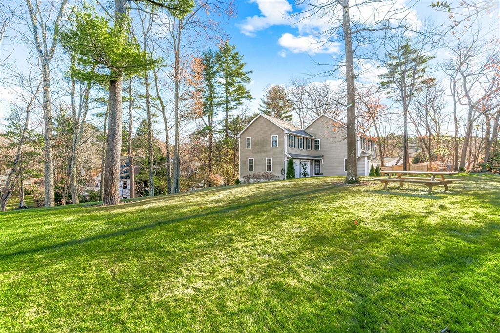5 Rolling Lane Natick, MA 01760 - Photo 28 of 30 a front view of a house with a yard