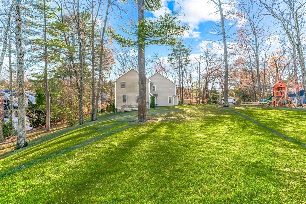5 Rolling Lane Natick, MA 01760 - Photo 29 of 30 a view of a house with a big yard and large trees