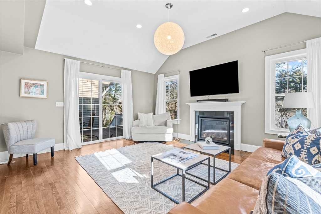 5 Rolling Lane Natick, MA 01760 - Photo 8 of 30 a living room with furniture a fireplace and a flat screen tv