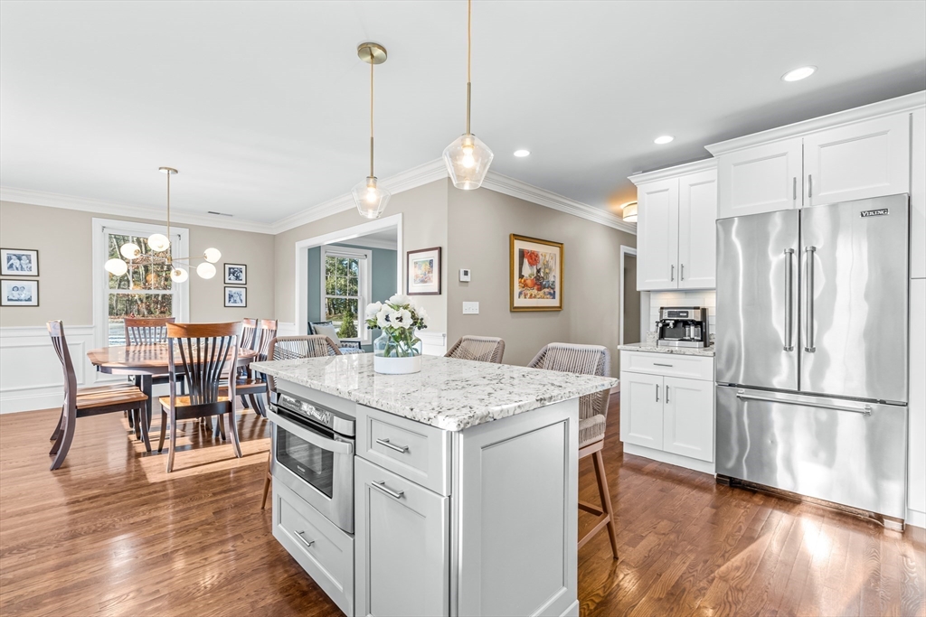 5 Rolling Lane Natick, MA 01760 - Photo 10 of 30 a kitchen with kitchen island a stove a refrigerator a dining table and chairs
