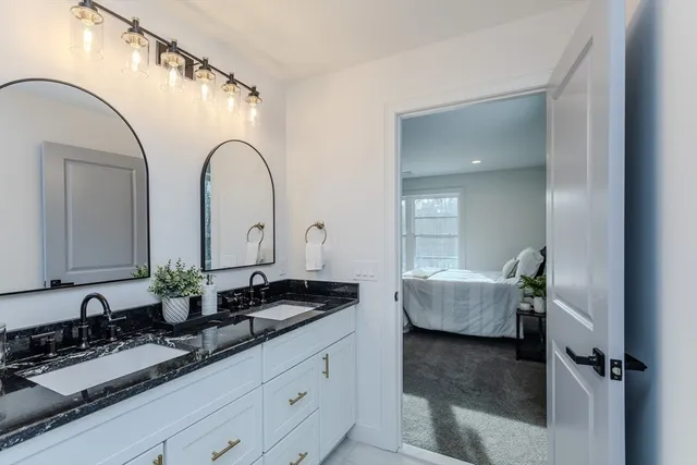 a en suite bathroom with sink and mirror
