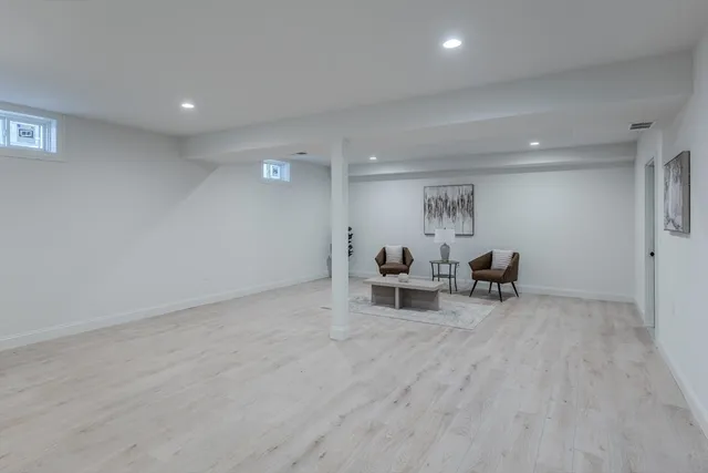 a view of a livingroom with furniture and lounge chair