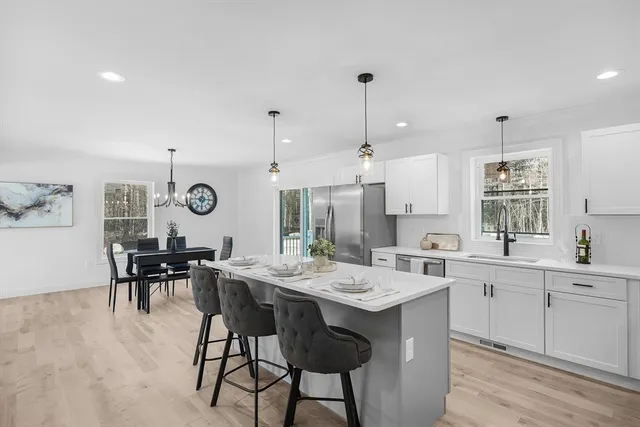 a large kitchen with a table and chairs