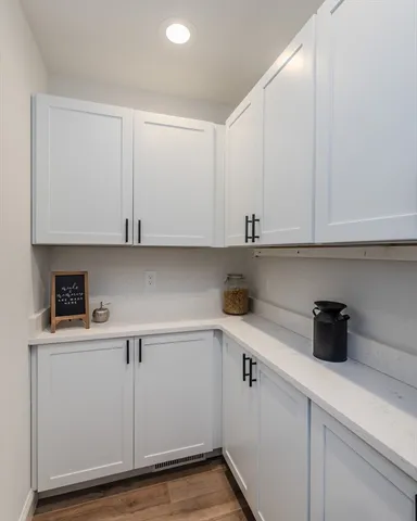 a kitchen with stainless steel appliances white cabinets and a sink