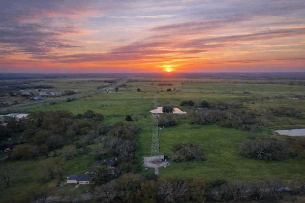 a view of a city with lush green forest