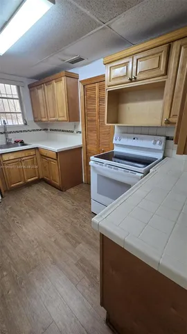 a kitchen with stainless steel appliances a stove and a sink