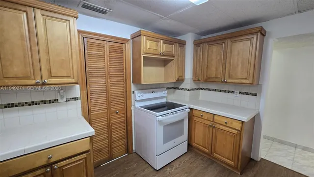 a kitchen with a stove and a cabinet