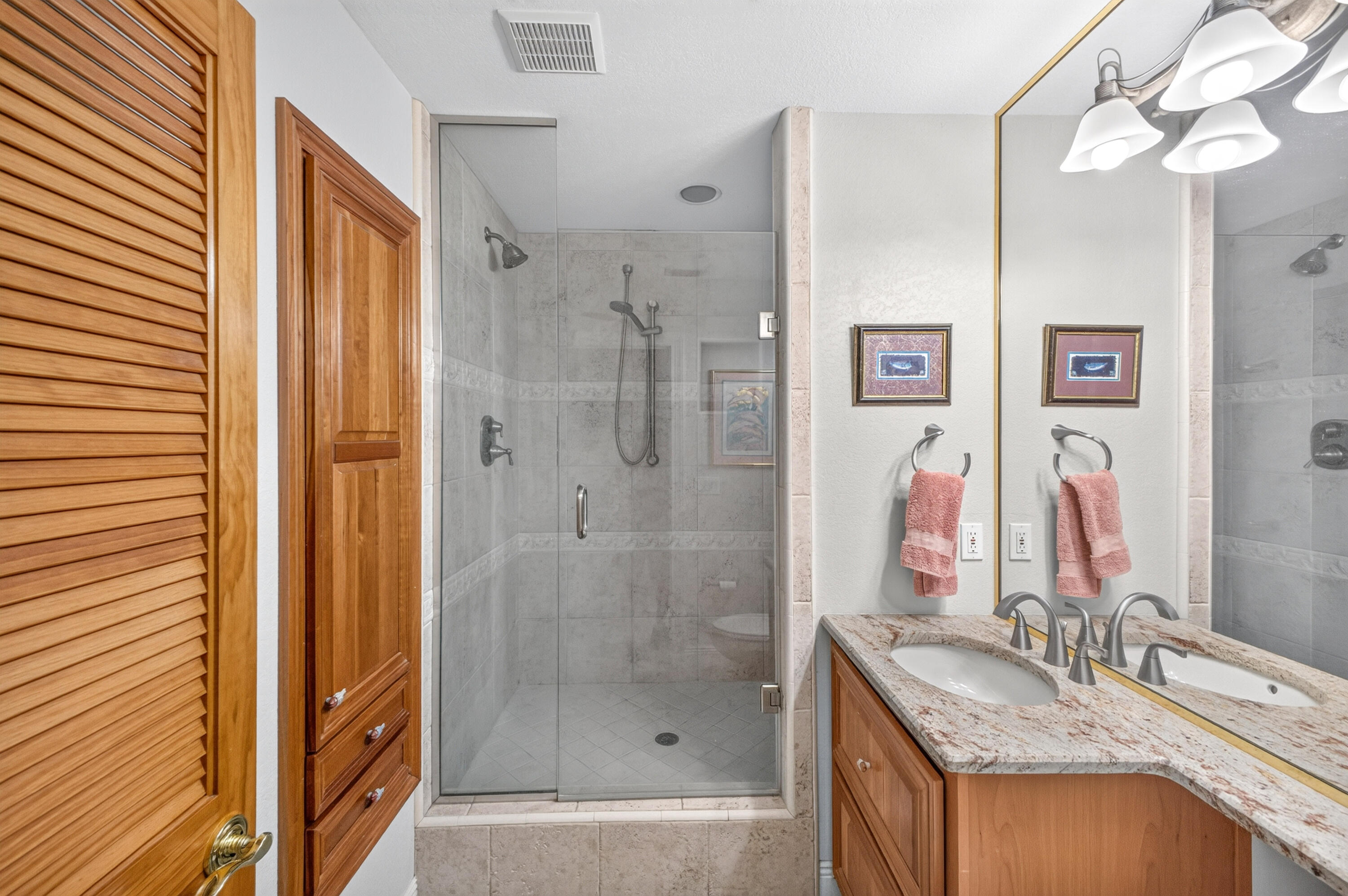 30 Moreno Point Road, Unit 703A Destin, FL 32541 - Photo 40 of 60 a bathroom with a granite countertop sink a mirror a shower and a bathtub