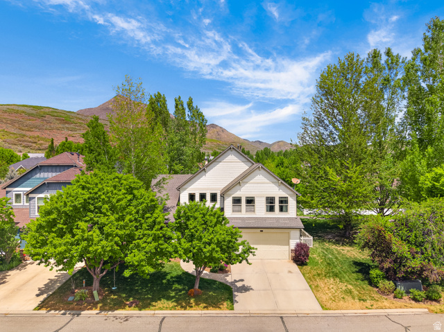557 Craftsman Way Midway, UT 84049 - Photo 54 of 59 Contemporary two-story residence featuring a light-colored facade, attached garage, and a sloped shingle roof