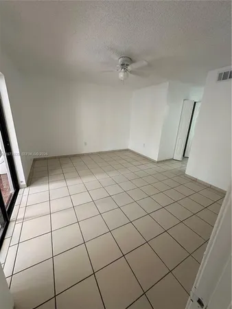 a view of an empty room and entryway