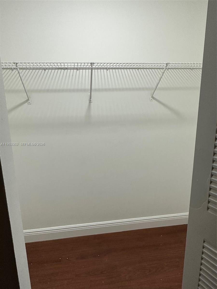 7155 Northwest 179th Street, Unit 304 Hialeah, FL 33015 - Photo 11 of 14 a view of a room with racks on the wall